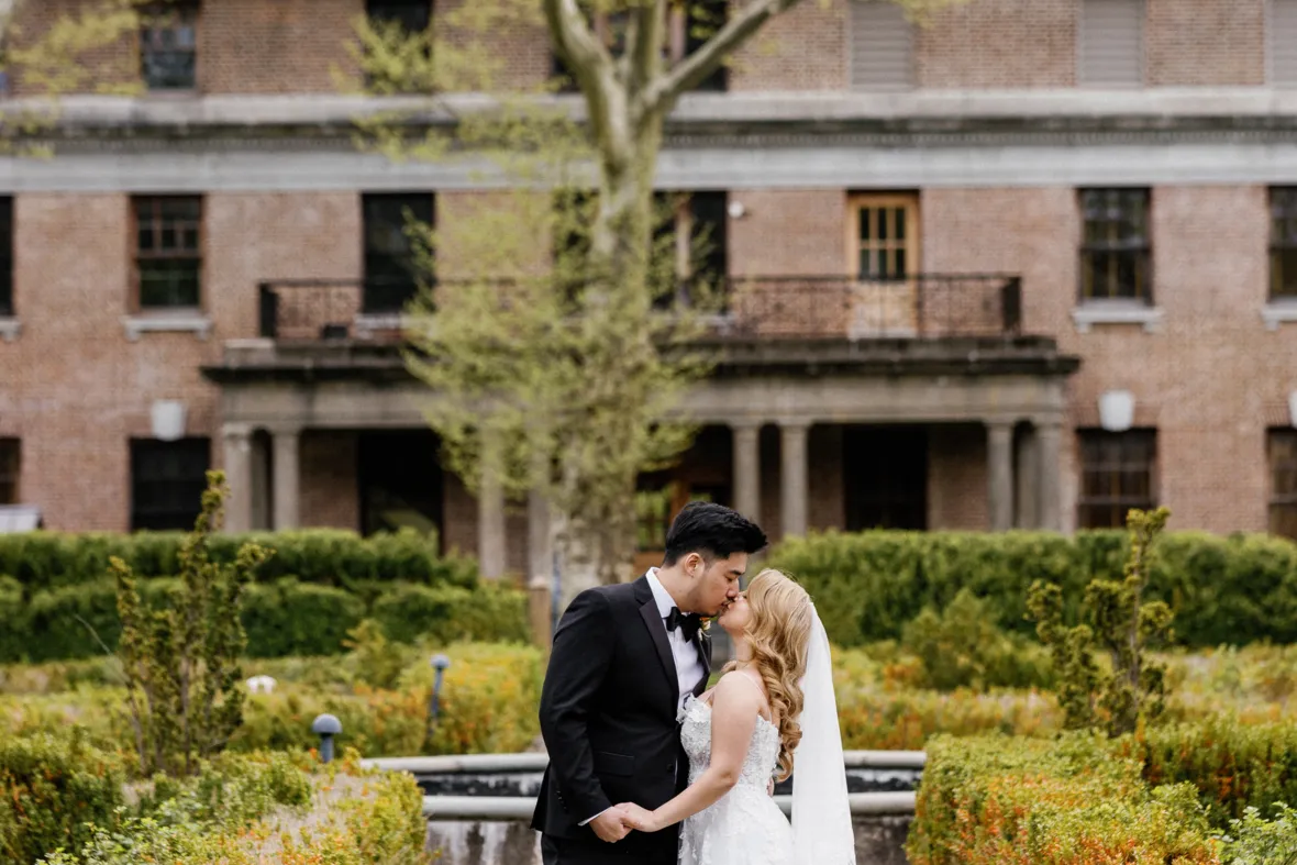 Couple kissing in Snug Harbor before wedding reception