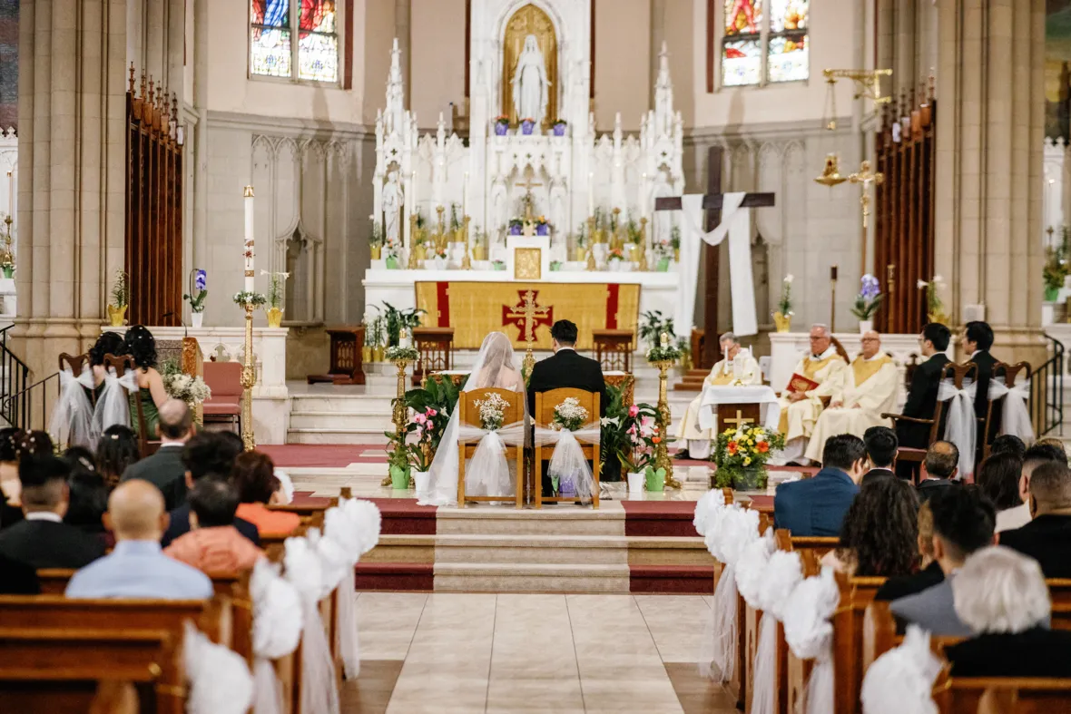 Bride and groom sitting during church wedding ceremony