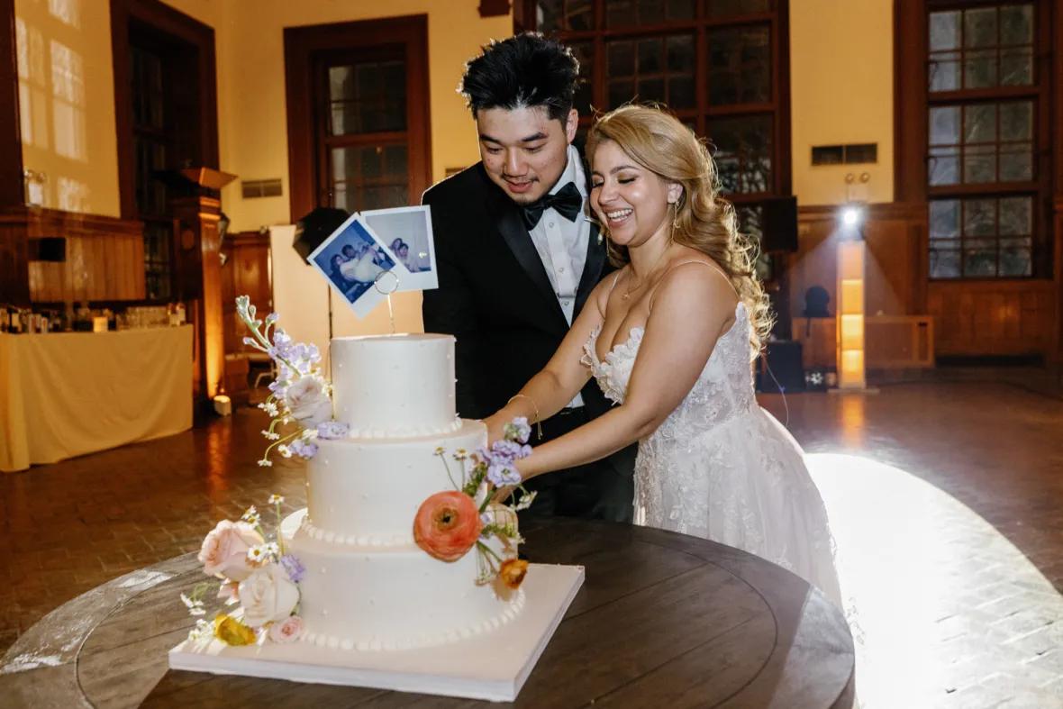 Bride and groom cutting the wedding cake