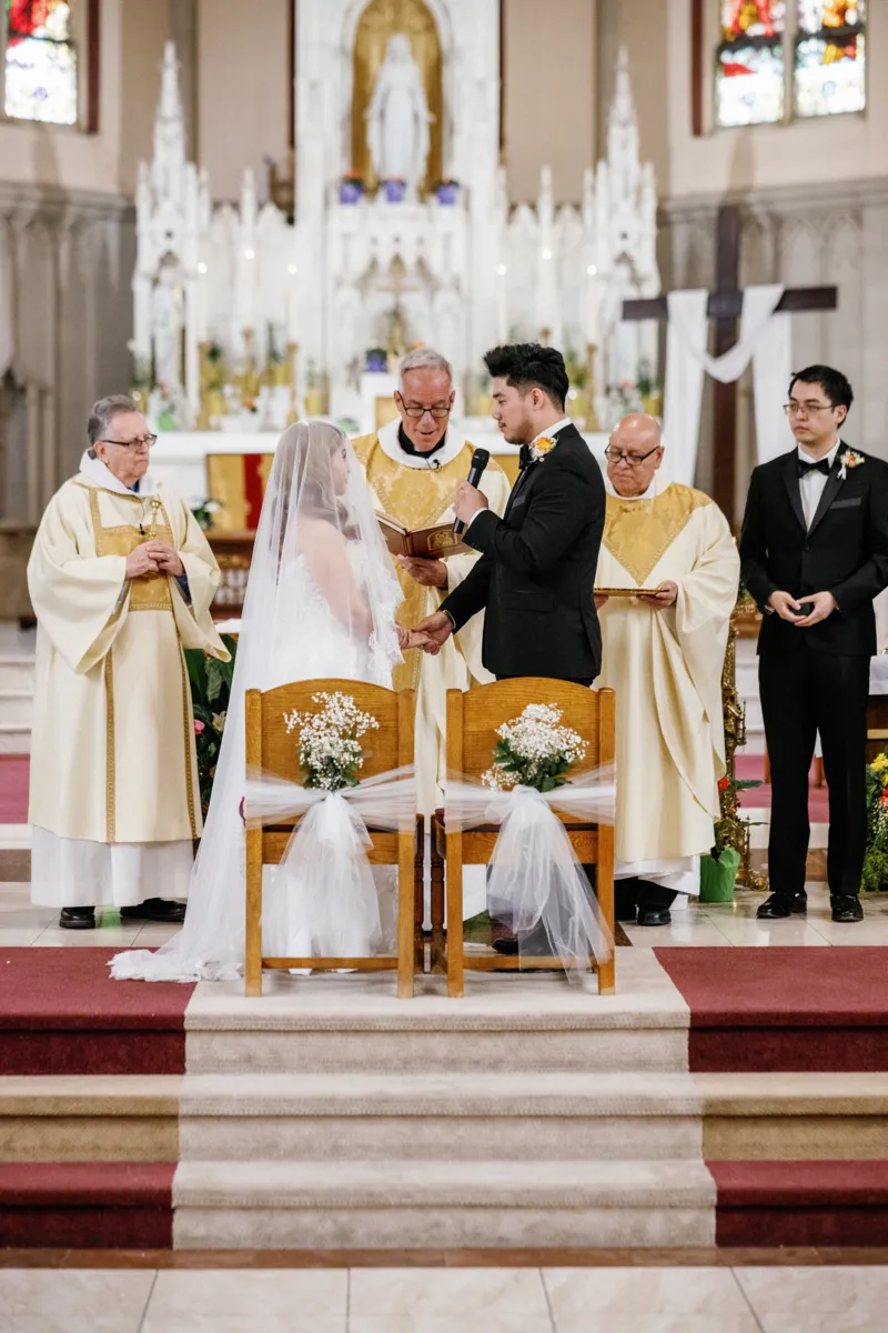 Groom reading wedding vows in church