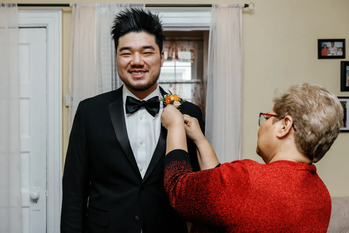 Mom helping groom get ready