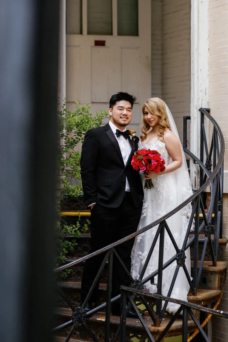 Bride and groom standing on steps