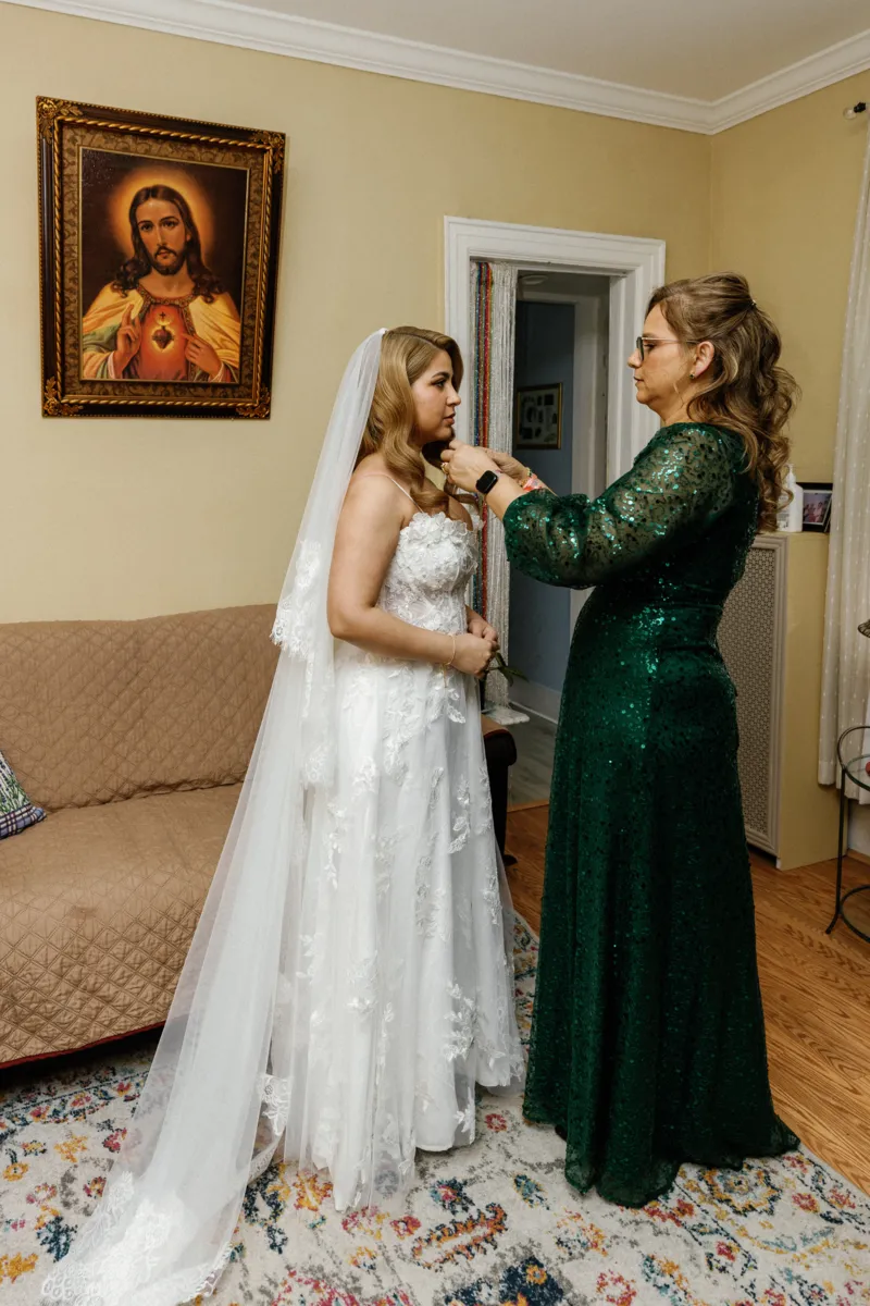 Mother helping bride get ready