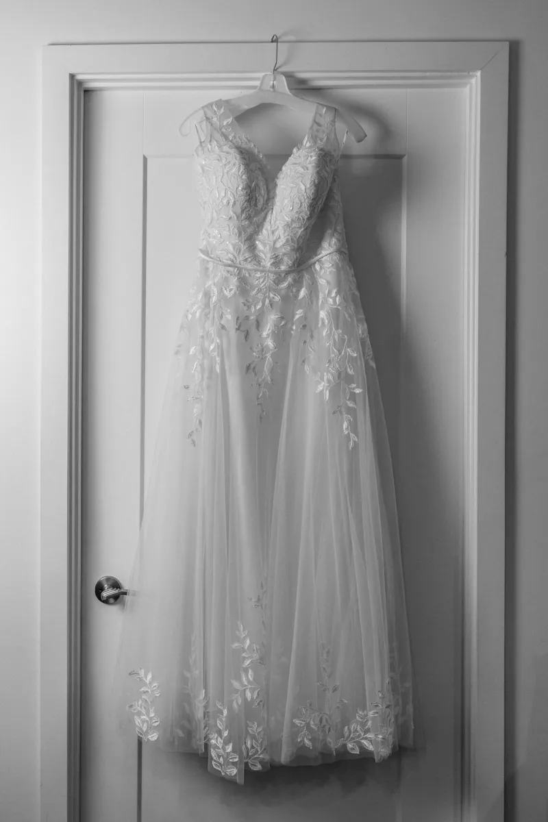 Wedding dress hanging on door