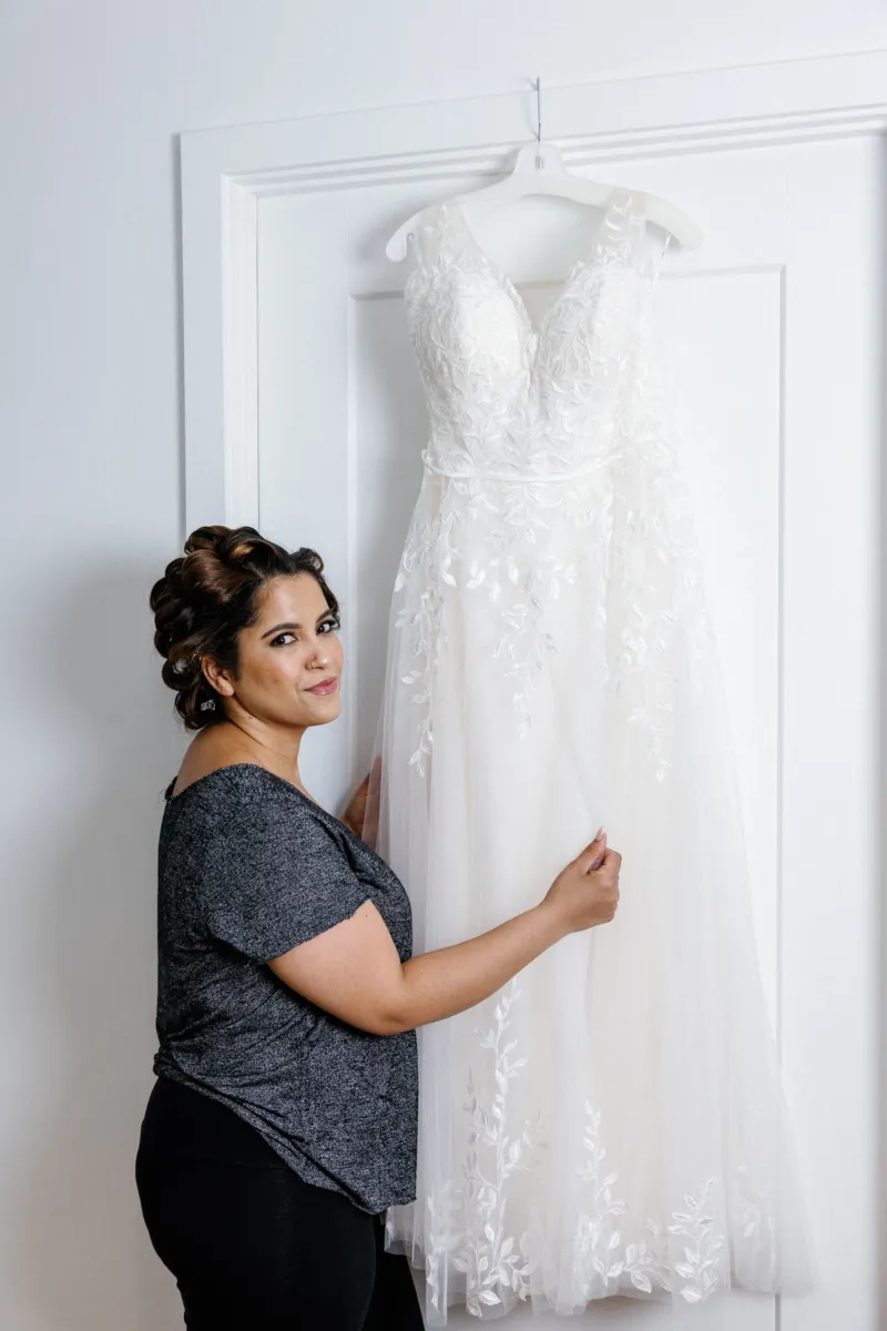 Bride holding wedding dress