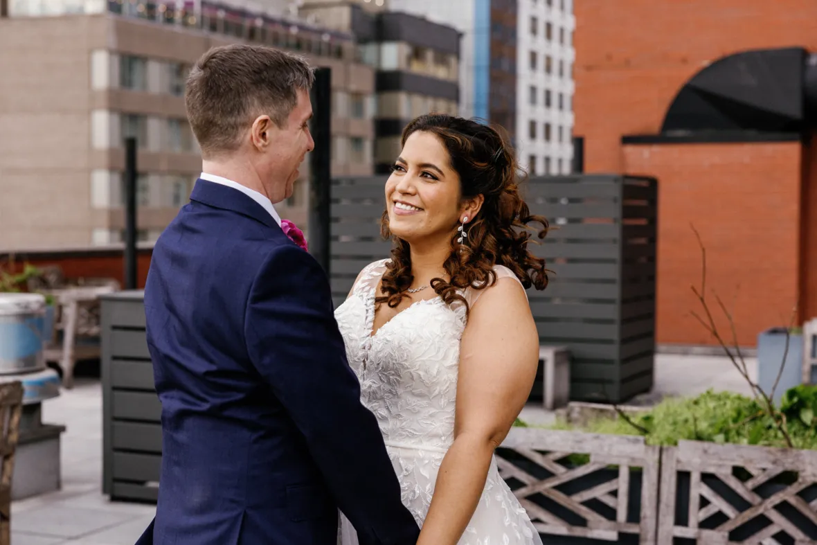 Bride and groom holding hands on rooftop