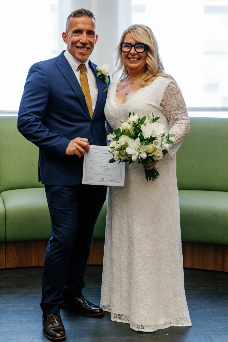 Couple holding marriage certificate