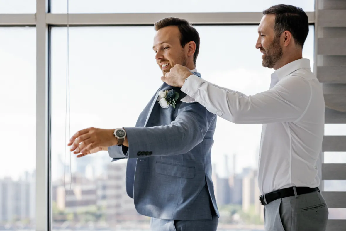 Gay couple helping each other get ready