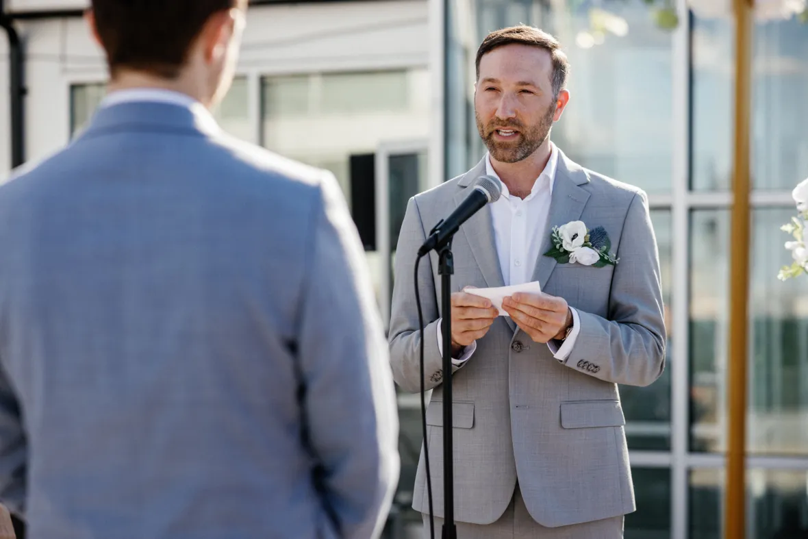 Groom reading personal wedding vows