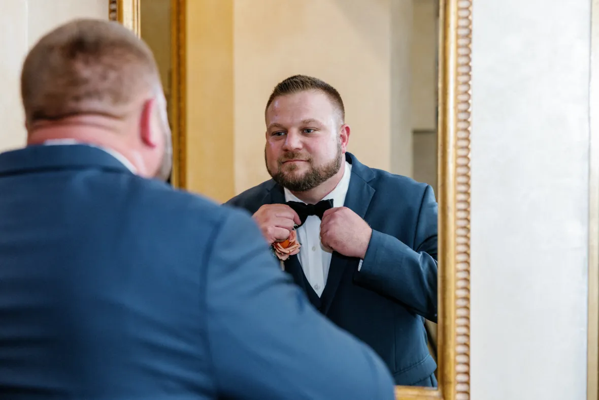 Groom fixing tie