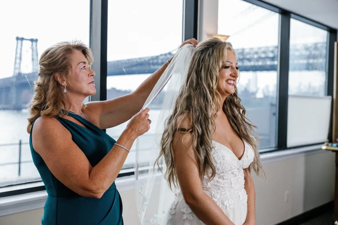 Mother helping bride put the veil on