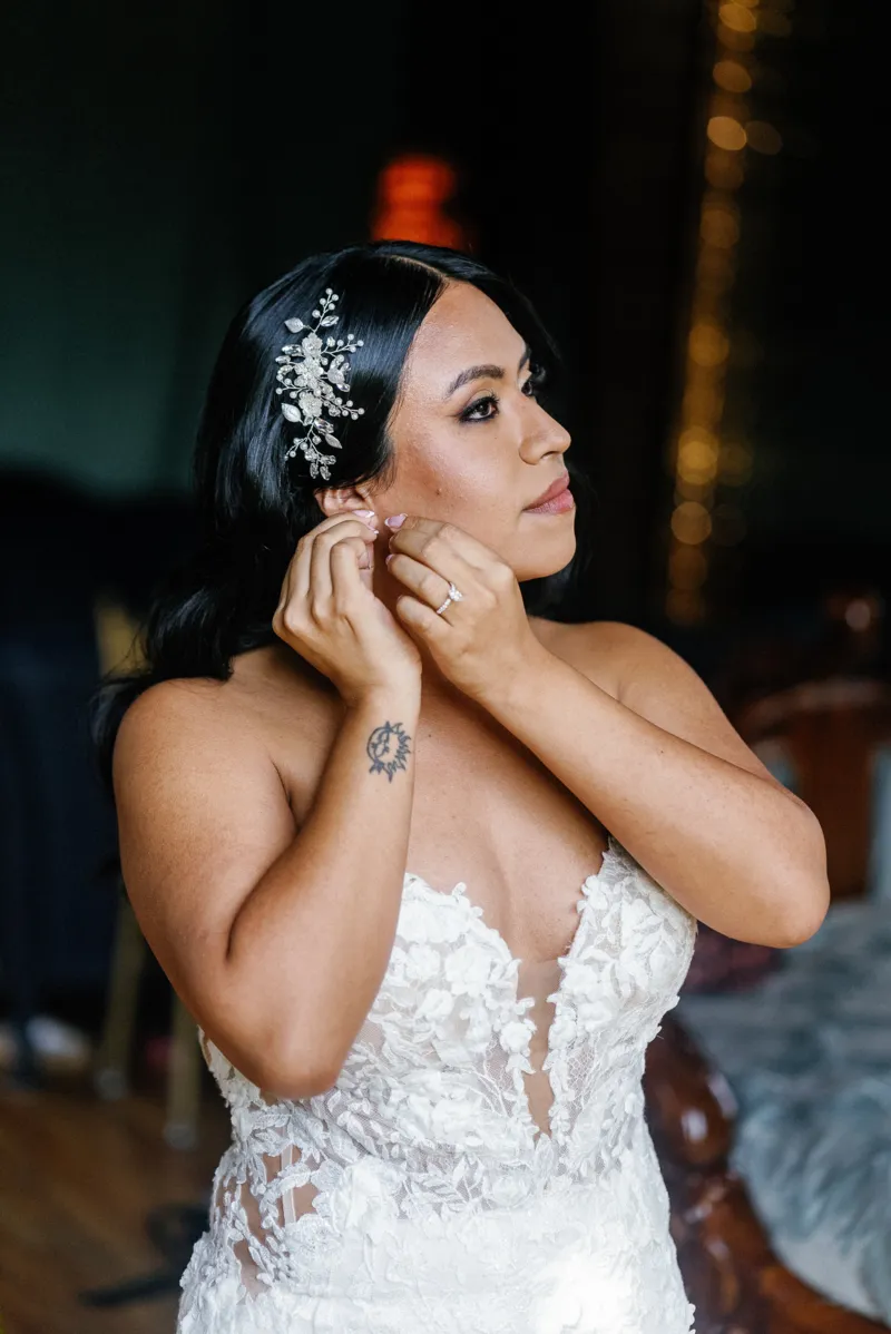 Bride putting the earring on