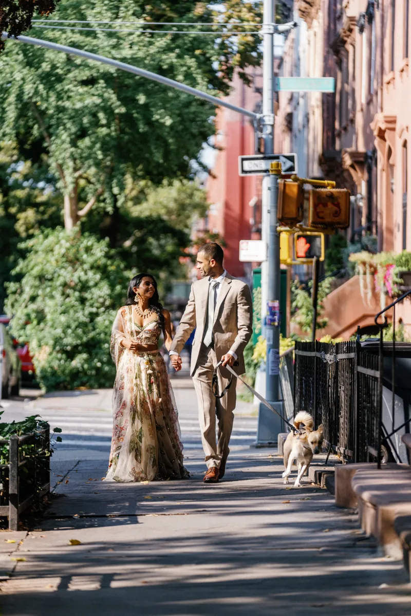 Indian couple walking a dog