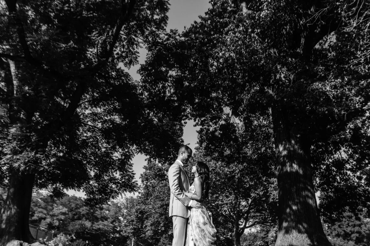 Black and white portrait of Indian bride and groom facing each other and hugging in Fort Greene Park