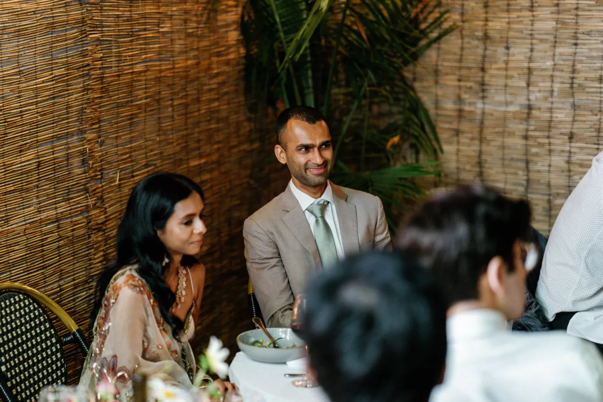 Bride and groom listening to wedding toast