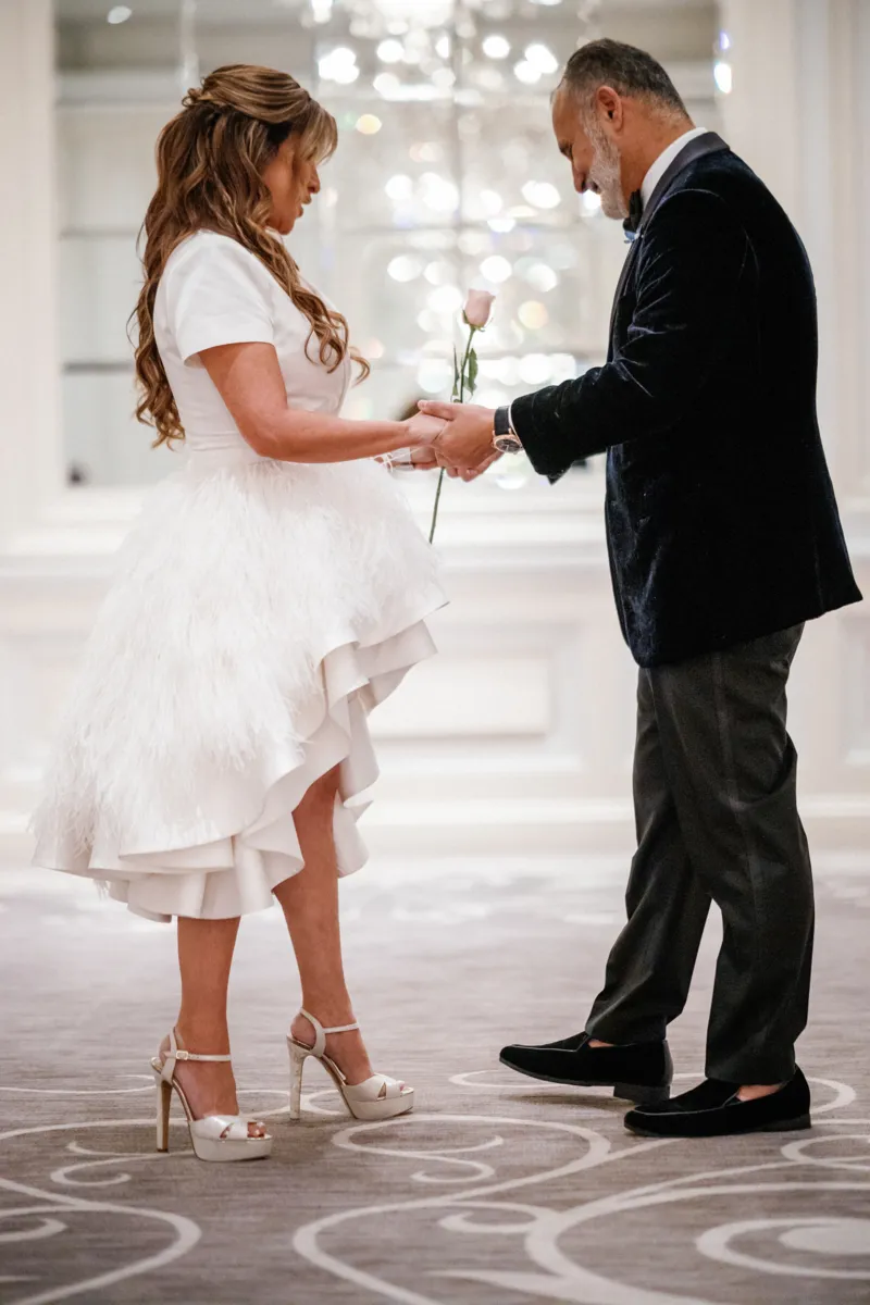 Groom looking at brides wedding dress during first look