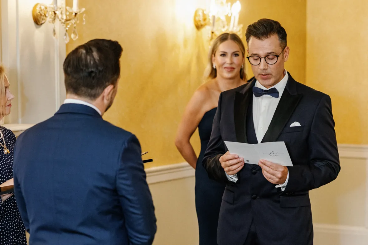 Groom reading personal wedding vows