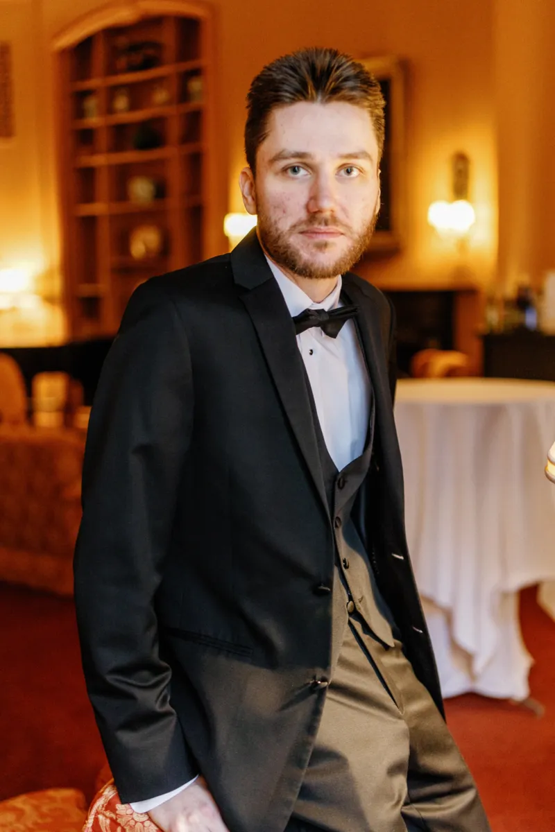 Groom sitting on chair back